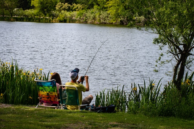People fishing at a pond