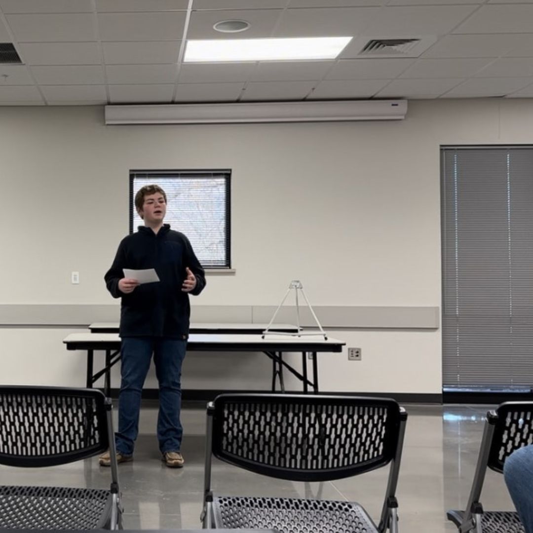 boy giving a presentation in a room