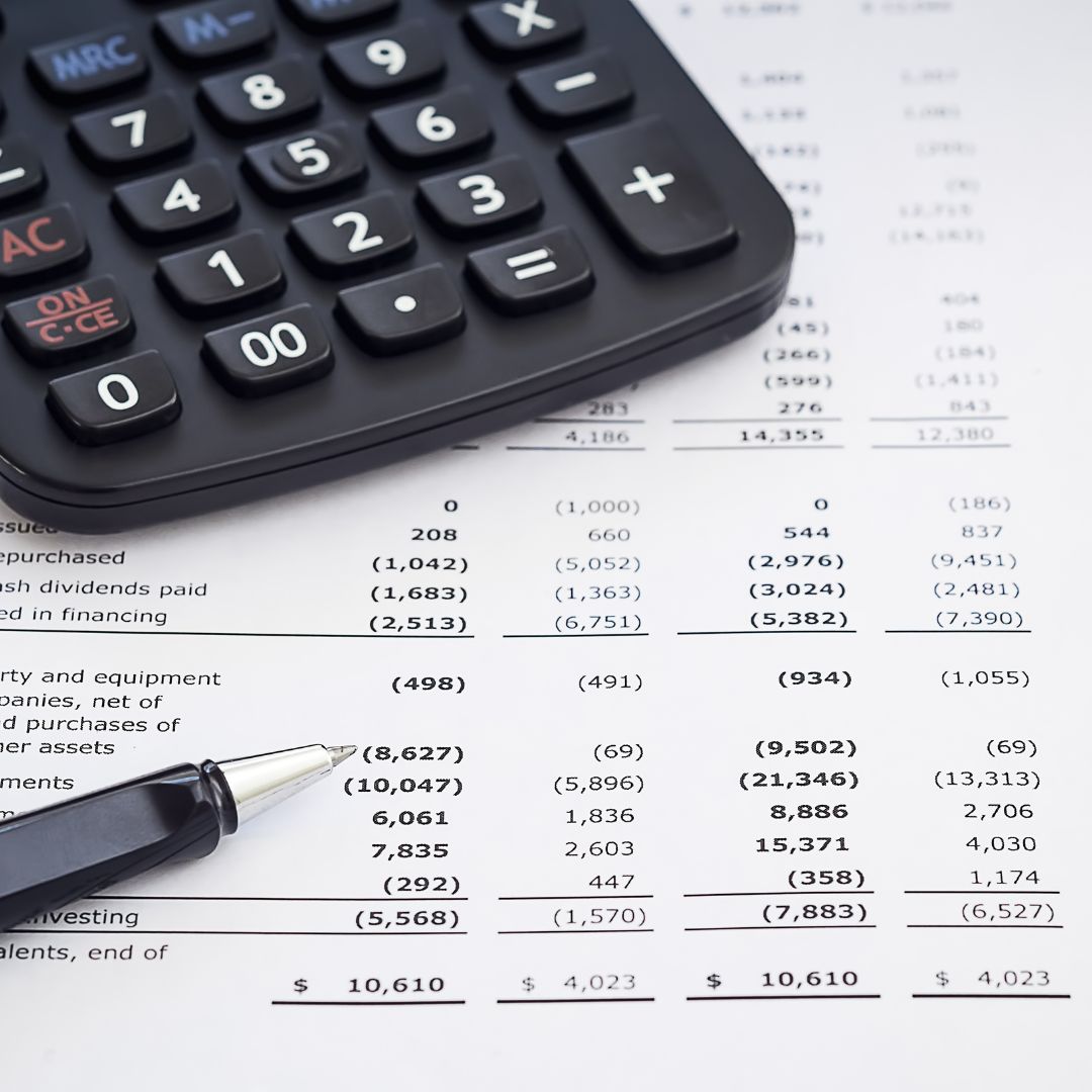 caculator, pen, and accounting sheet