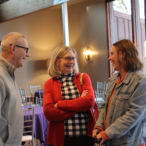 three people laughing happily