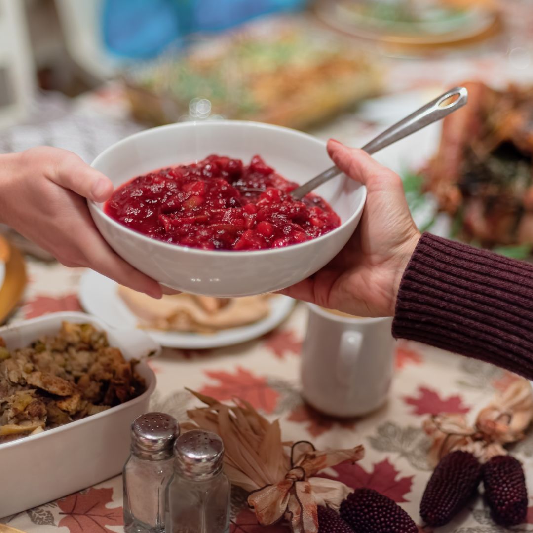holiday meal. hands passing a bowl of food
