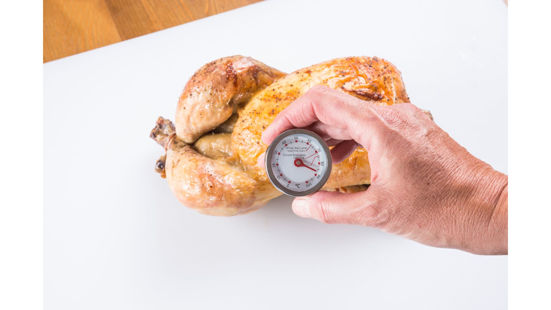 cooked  chicken's temperature being checked
