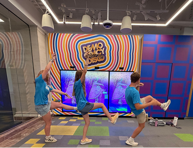CWF kids playing a disco game in a museum